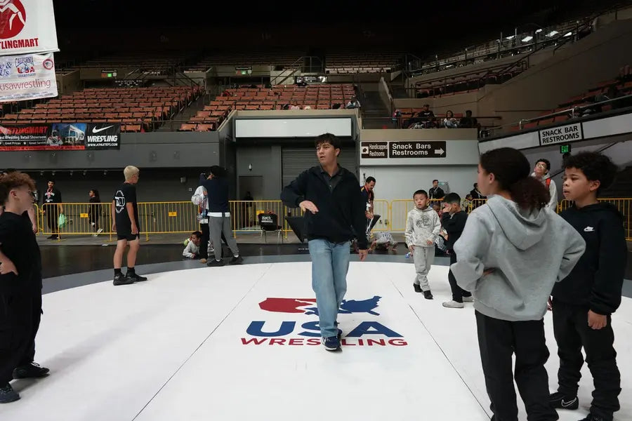 Athletes warming up on the arena mat before a USA Wrestling event