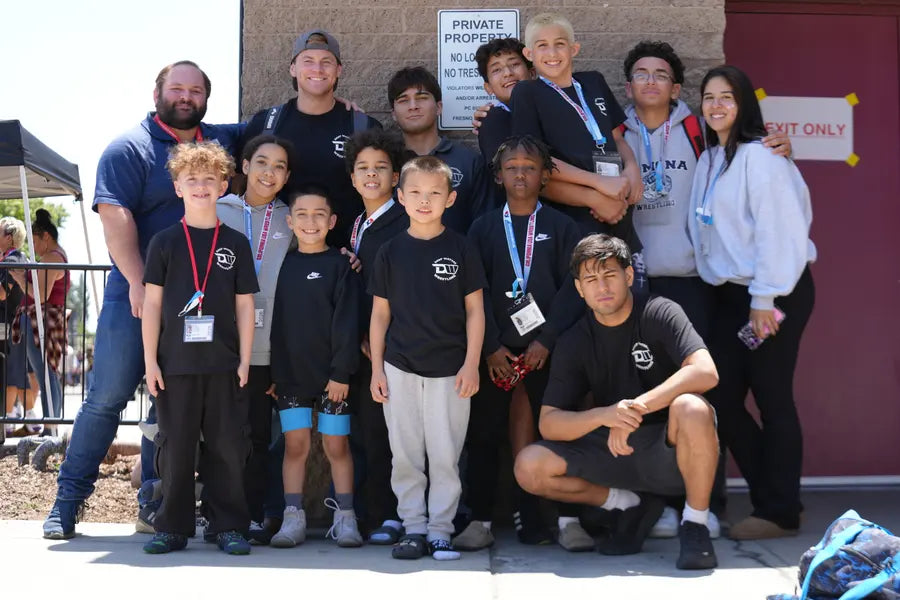 Wrestlers and coaches posed together outside the venue on tournament day